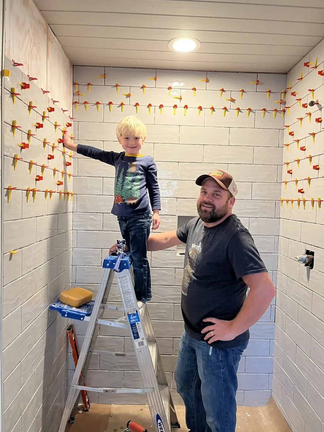 Michael Felder setting tile in a shower