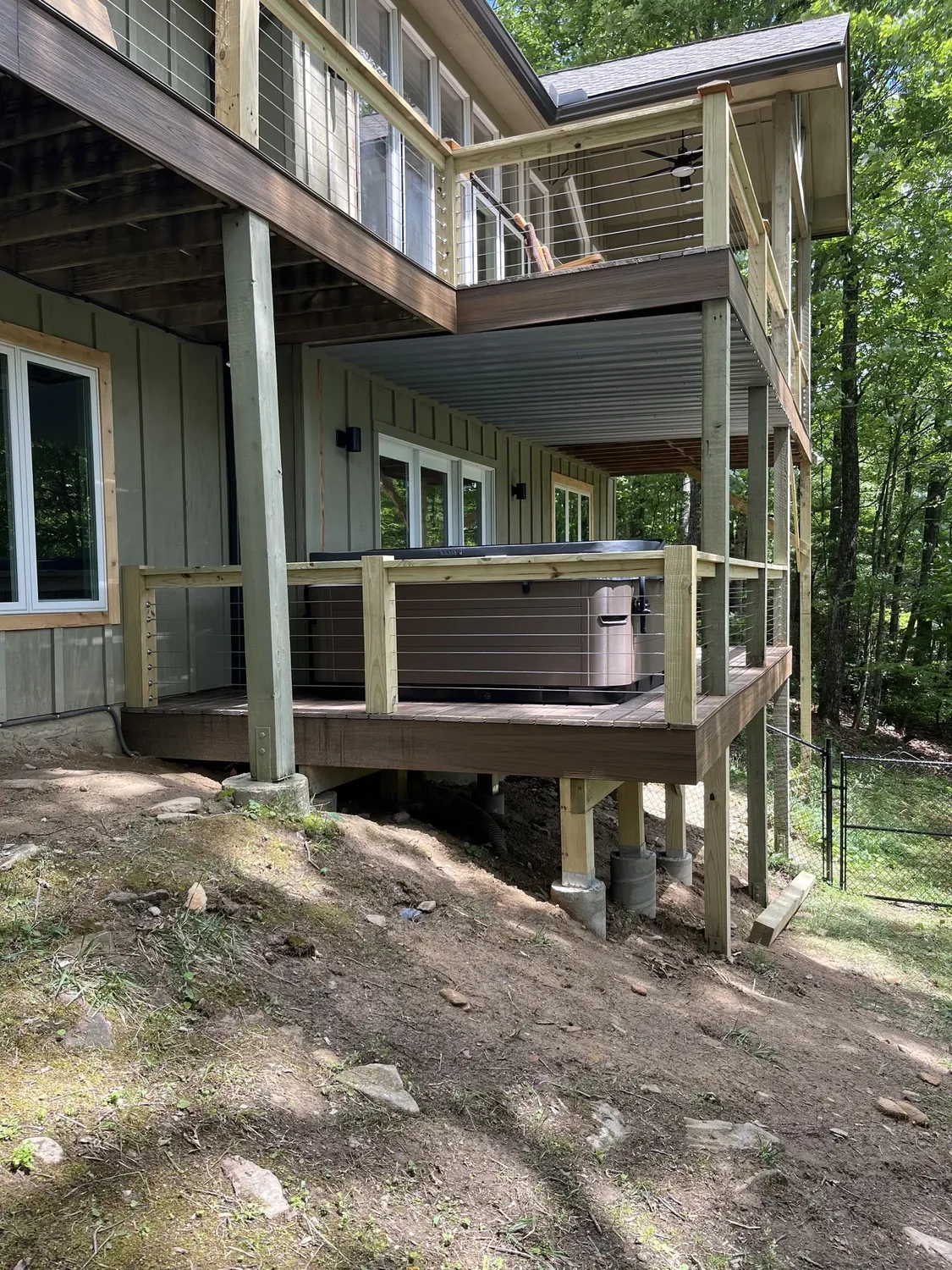Composite deck with wire railing and reinforced hot tub support