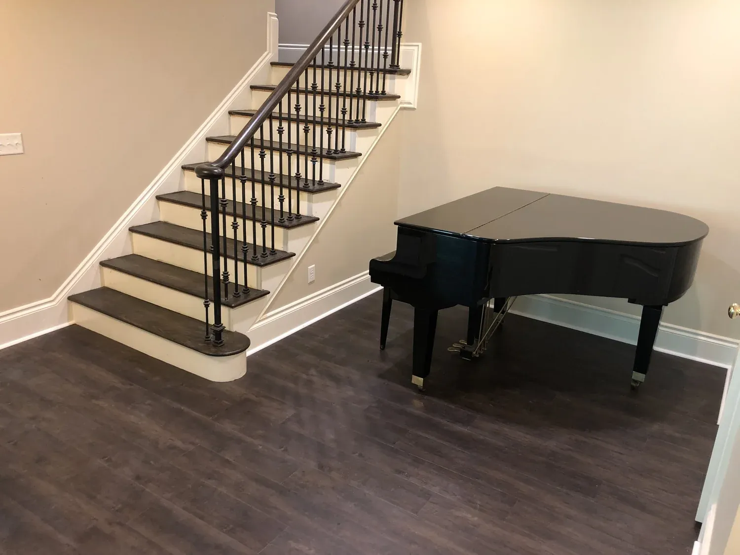Luxury vinyl plank flooring in entryway with staircase